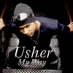 Album cover of Usher's "My Way", which features 18-year-old Usher looking up to the camera. He is standing on a staircase, wearing a black shirt, pants, and beanie, along with silver glasses on his head and a chain.