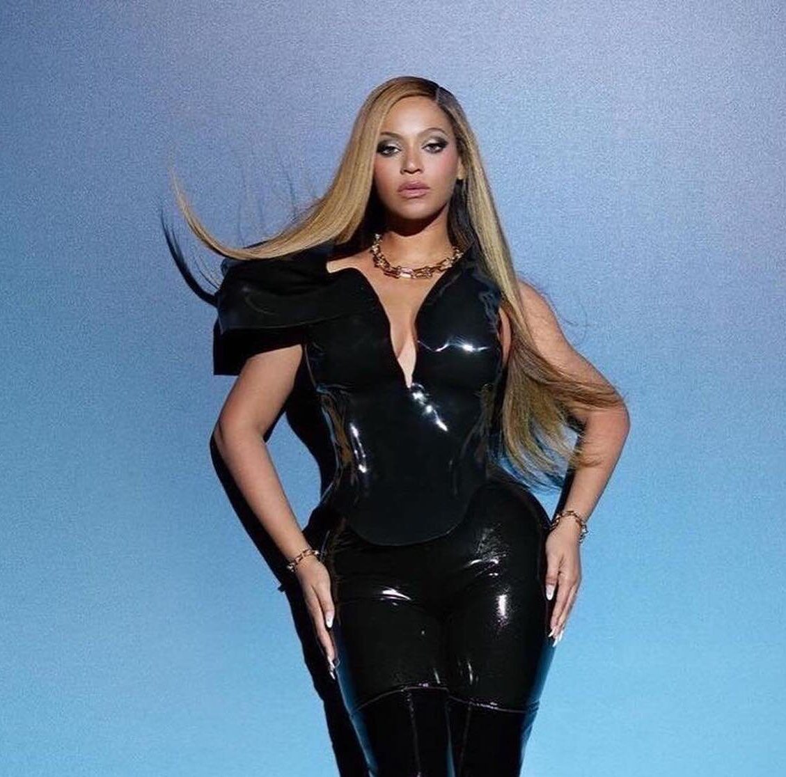 Artist image for Beyonce, which features a picture of Beyonce for her Tiffany's ad campaign. She is wearing a black leather dress and has long, straight honey-blonde hair. She is posed in front of a blue gradient background.